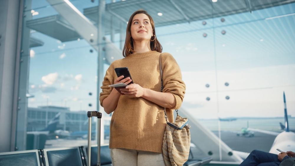 Airport,Terminal:,Happy,Traveling,Caucasian,Woman,Waiting,At,Flight,Gates